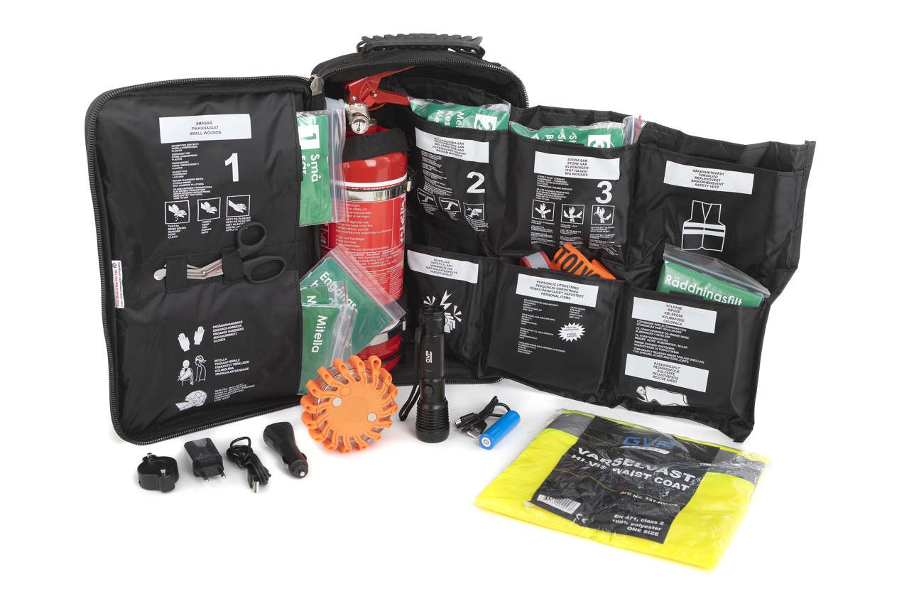 Första hjälpen väska med sårvård och brandsläckare
